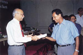 Test batsman T E Srinivasan receiving his copy of the book from former Test player, Test selector and state captain C D Gopinath. 