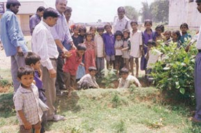 Children of a local school seen planting a sapling on World Environment Day