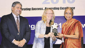 Jaya Krishnaswamy receiving the award from Heather Grady, Vice President of The Rockefeller Foundation. Ashvin Dayal, Managing Director of The Rockefeller Foundation